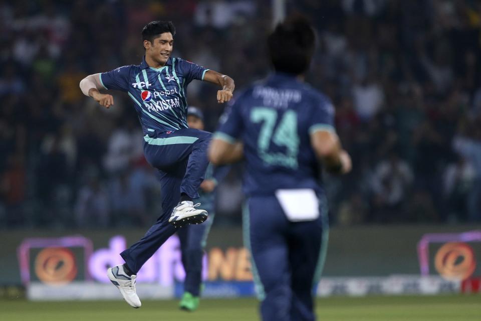 Pakistan's Mohammad Hasnain jumps to celebrate after taking the wicket of England's Alex Hales during the seventh twenty20 cricket match between Pakistan and England, in Lahore, Pakistan, Sunday, Oct. 2, 2022. (AP Photo/K.M. Chaudary)