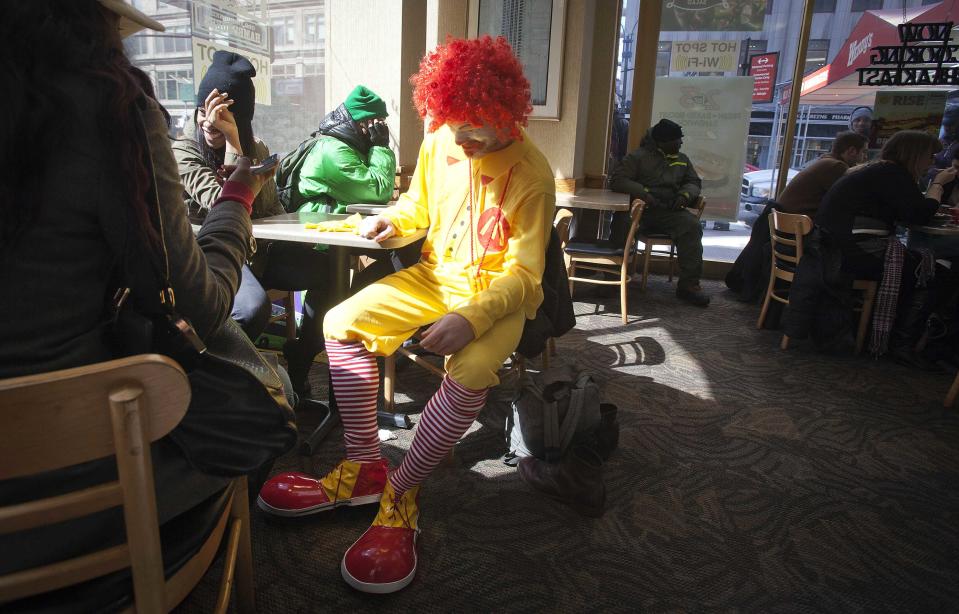 A protester dressed up as Ronald McDonald