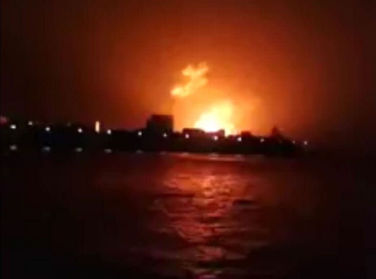 This frame grab taken from video footage provided by Indian broadcaster NWS early on August 14, 2013, shows a fire at the Indian Naval Dockyard in Mumbai. Indian divers and engineers have struggled to refloat a submarine that exploded with 18 crewmen on board, as the prime minister voiced "deep regret" at the blast which is feared to have left no survivors