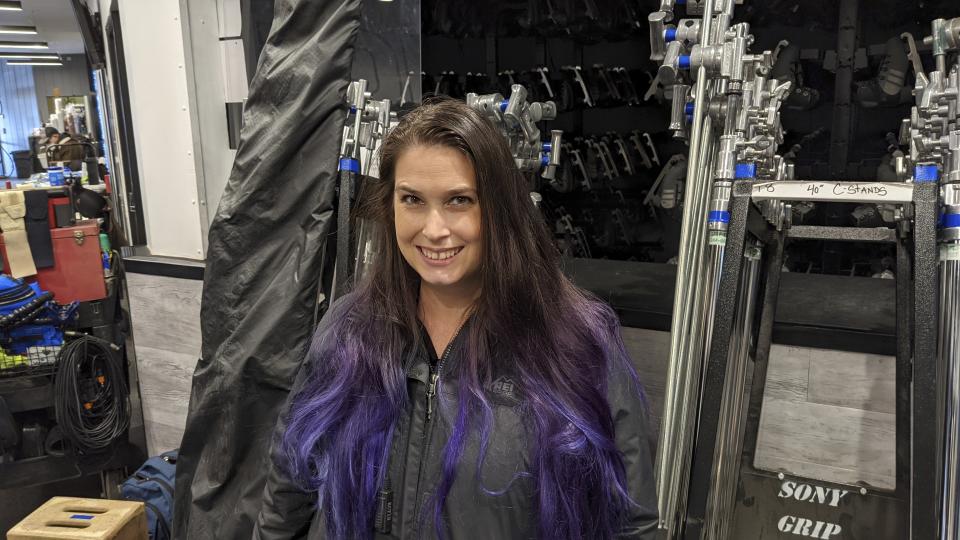 Crew member Brandy Tannahill appears on the set of of a TV sitcom in Los Angeles on Nov. 9, 2021. Tannahill, a member of the International Alliance of Theatrical Stage Employees, will vote on a proposed three-year union contract with Hollywood producers. (Lauren Callahan via AP)