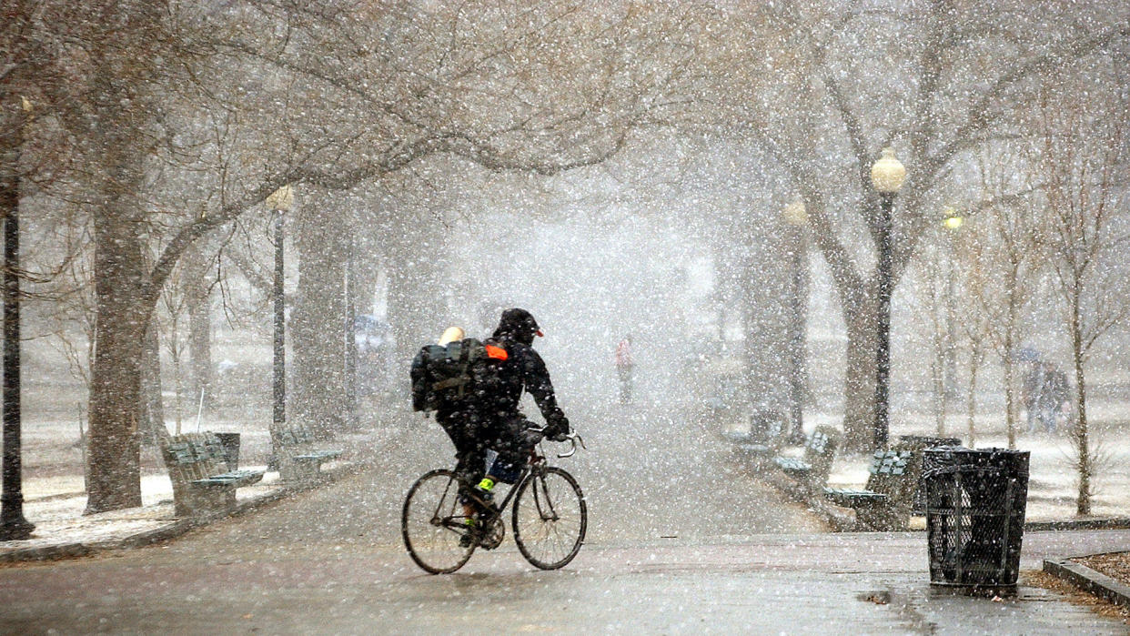  People hurry through the Boston Common during a windy snow squall in March 2004. 