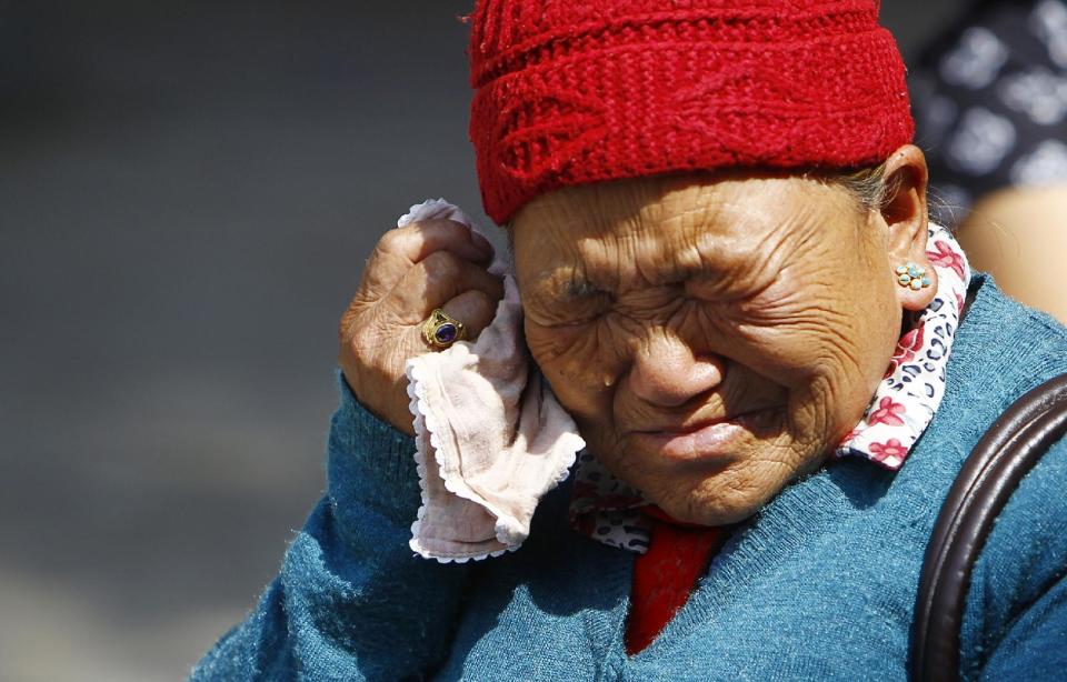 Mother of Nepalese mountaineer Ang Kaji Sherpa, killed in an avalanche on Mount Everest, cries while she waits for his body at Sherpa Monastery in Katmandu, Nepal, Saturday, April 19, 2014. (AP Photo/Niranjan Shrestha)