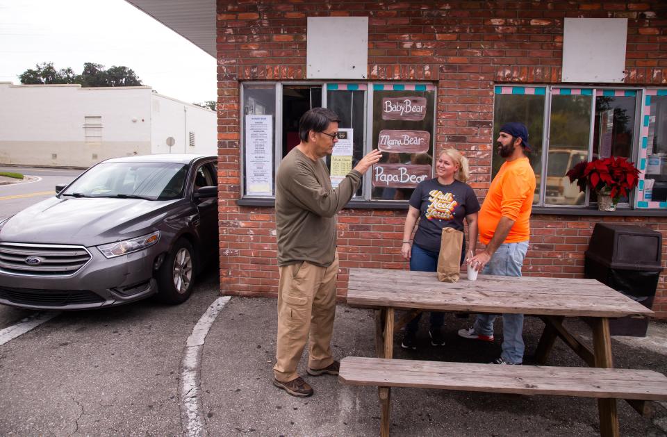 Larry C. Mayhew, left, talks with Christina and Joe Licari as they wait for their lunch Dec. 4 at Hungry Bear. Mayhew’s father started the restaurant in 1973.