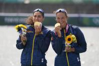 Gold medalist Ancuta Bodnar and Simona Radis of Romania pose after winning the women's rowing double sculls final at the 2020 Summer Olympics, Wednesday, July 28, 2021, in Tokyo, Japan. (AP Photo/Darron Cummings)