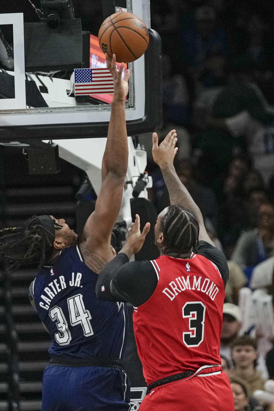 Orlando Magic center Wendell Carter Jr. (34) blocks a shot by Chicago Bulls center Andre Drummond (3) during the first half of an NBA basketball game, Saturday, Feb. 10, 2024, in Orlando, Fla. (AP Photo/John Raoux)