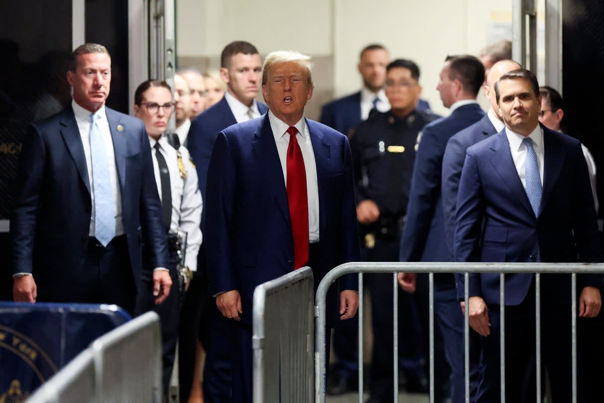 Donald Trump speaks to reporters outside a criminal courtroom doors in Manhattan on 25 March. (POOL/AFP via Getty Images)