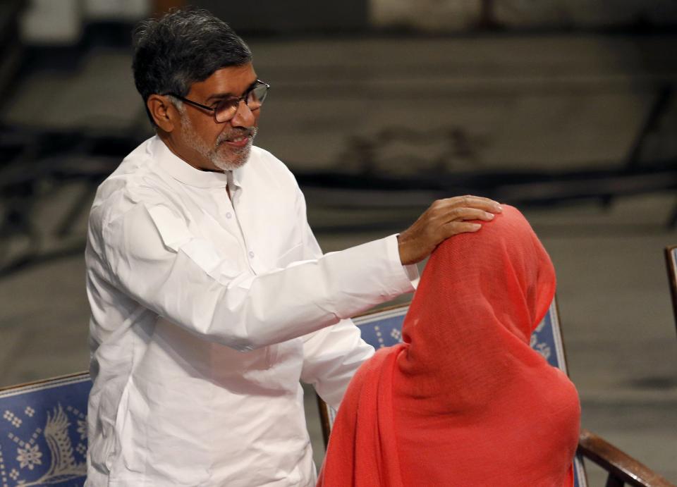 Nobel Peace Prize laureate Kailash Satyarthi (L) congratulates Malala Yousafzai after delivering her speech during the Nobel Peace Prize awards ceremony at the City Hall in Oslo December 10, 2014. Pakistani teenager Yousafzai, shot by the Taliban for refusing to quit school, and Indian activist Satyarthi received their Nobel Peace Prizes on Wednesday after two days of celebration honouring their work for children's rights. REUTERS/Suzanne Plunkett (NORWAY - Tags: SOCIETY)