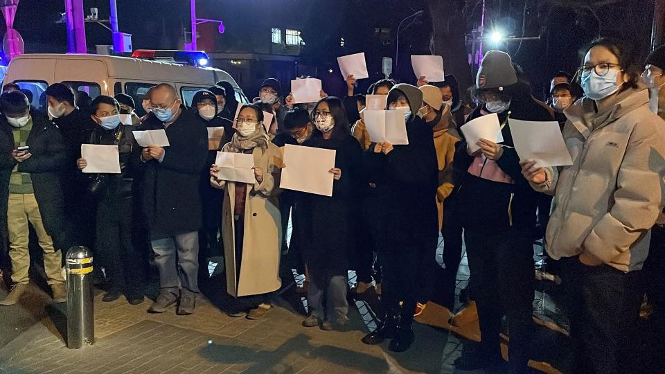 Protesters gather along a street during a rally for the victims of a deadly fire as well as a protest against China's harsh Covid-19 restrictions in Beijing on November 28, 2022. - A deadly fire on November 24, 2022 in Urumqi, the capital of northwest China's Xinjiang region, has become a fresh catalyst for public anger, with many blaming Covid lockdowns for hampering rescue efforts, as hundreds of people took to the streets in China's major cities on November 27, 2022 to protest against the country's zero-Covid policy in a rare outpouring of public anger against the state. Authorities deny the claims. (Photo by Michael Zhang / AFP) (Photo by MICHAEL ZHANG/AFP via Getty Images)