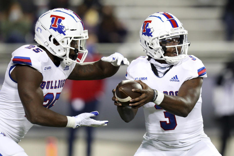 Louisiana Tech running back Greg Garner (25) and quarterback Aaron Allen (3) fake a handoff against TCU in the first half during an NCAA college football game, Saturday, Dec. 12, 2020. (AP Photo/Richard W. Rodriguez)