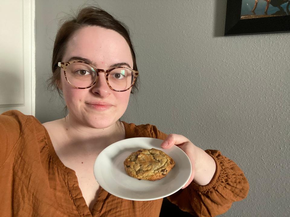 paige bennett holding a cookie on a plate