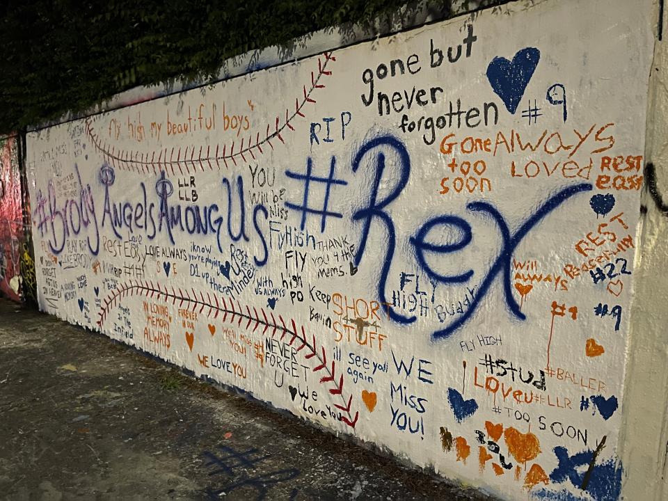 A mural painted Wednesday on the Northwest 34th Street wall in Gainesville honors the lives of youth baseball players Rex Reinhart, 14, and Brody Reinhart, 11, who were killed by their father, Paul O. Reinhart, 46, on May 4, 2021 at the family's vacation home near Suwannee in western Florida.