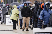 FILE - In this Feb. 19, 2021, file photo, people wait in line at a 24-hour, walk-up COVID-19 vaccination clinic hosted by the Black Doctors COVID-19 Consortium at Temple University's Liacouras Center in Philadelphia. States are scrambling to catch up on coronavirus vaccinations after bad weather last week led to clinic closures and shipment backlogs. (AP Photo/Matt Rourke, File)