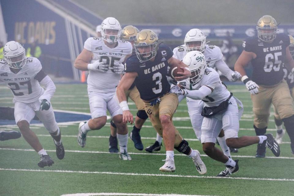 UC Davis Aggies running back Lan Larison (3) rushes for 22 yards in the second half of the Causeway Classic against the Sacramento State Hornets on Saturday.