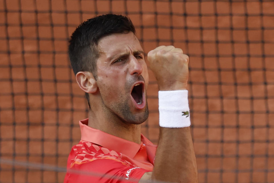 Serbia's Novak Djokovic celebrates winning his quarterfinal match of the French Open tennis tournament against Russia's Karen Khachanov in four sets, 4-6, 7-6 (7-0), 6-2, 6-4, at the Roland Garros stadium in Paris, Tuesday, June 6, 2023. (AP Photo/Jean-Francois Badias)