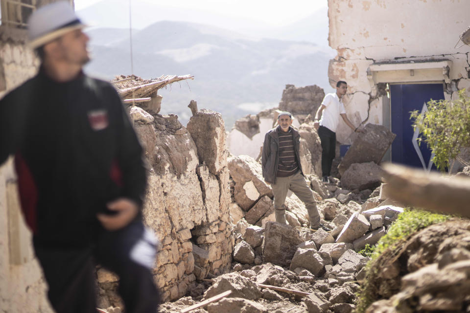 People inspect their damaged homes after an earthquake in Moulay Brahim village, near Marrakech, Morocco, Saturday, Sept. 9, 2023. A rare, powerful earthquake struck Morocco late Friday night, killing more than 800 people and damaging buildings from villages in the Atlas Mountains to the historic city of Marrakech. But the full toll was not known as rescuers struggled to get through boulder-strewn roads to the remote mountain villages hit hardest. (AP Photo/Mosa'ab Elshamy)