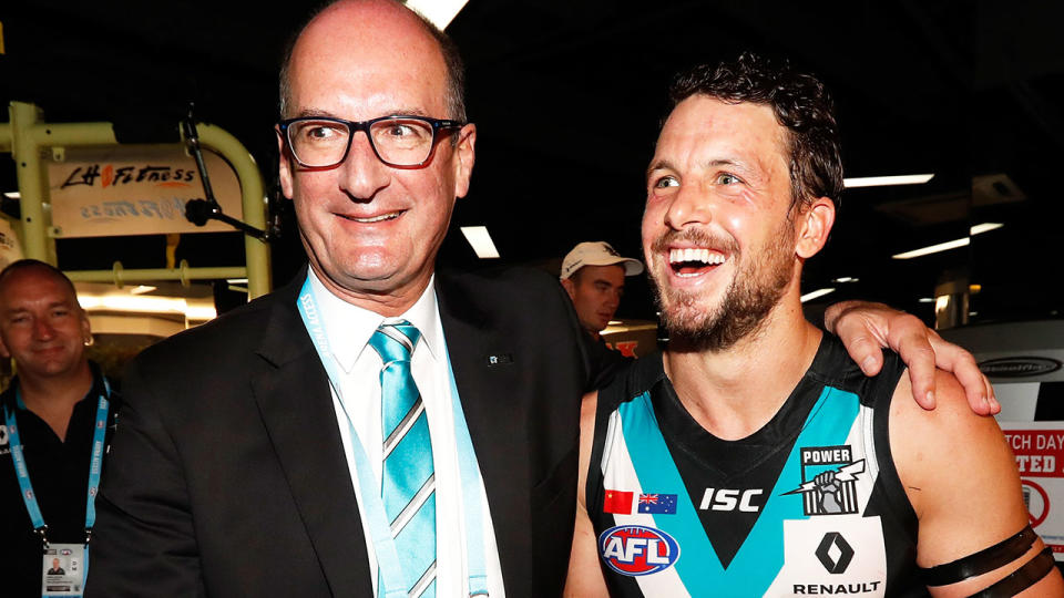 David Koch, pictured with Power star Travis Boak, took a surprising shot at Port Adelaide assistant coach Michael Voss.