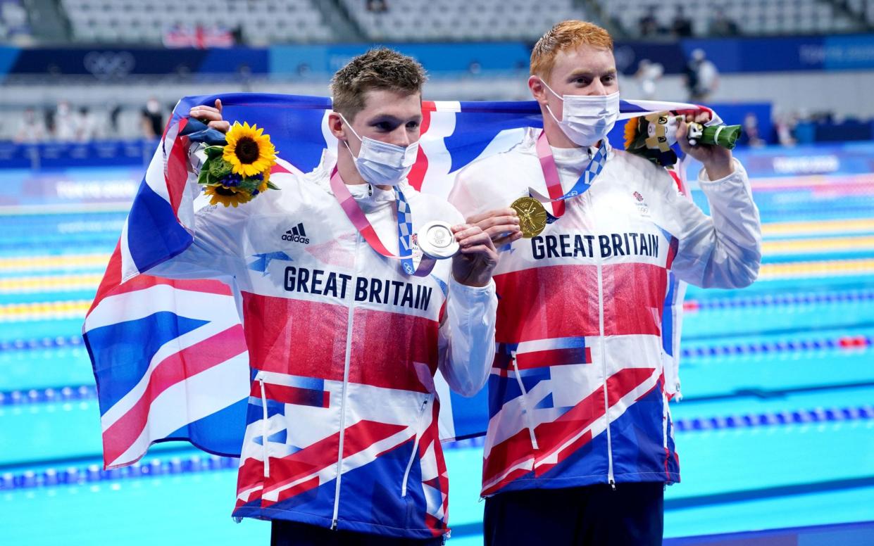 Great Britain's Tom Dean (right) with his gold medal after winning the Men's 200m Freestyle Final alongside Great Britain's Duncan Scott with his silver medal at the Tokyo Aquatics Centre on the fourth day of the Tokyo 2020 Olympic Games in Japan. - PA