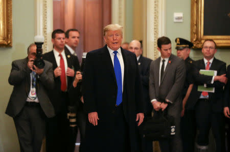 FILE PHOTO - U.S. President Donald Trump talks to reporters down the hall as the president departs a closed Senate Republican policy lunch on Capitol Hill in Washington, U.S., March 26, 2019. REUTERS/Leah Millis