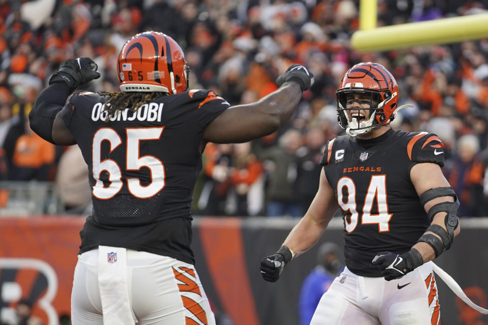 Cincinnati Bengals' Sam Hubbard (94) reacts with Larry Ogunjobi (65) after Hubbard sack Las Vegas Raiders quarterback Derek Carr during the first half of an NFL wild-card playoff football game, Saturday, Jan. 15, 2022, in Cincinnati. (AP Photo/Jeff Dean)