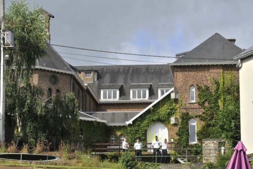 Belgian police stand guard outside a convent in Malonne near Namur that has agreed to house on parole Michelle Martin, the ex-wife and accomplice of notorious Belgian paedophile serial killer Marc Dutroux