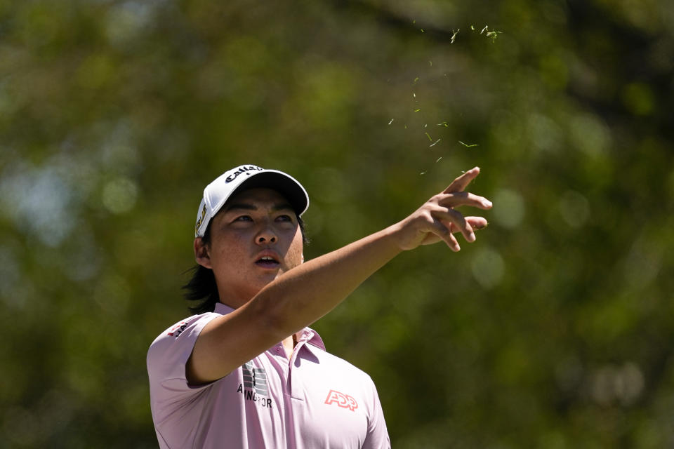 Min Woo Lee, of Australia, tests the wind before teeing off on the fourth hole during the final round at the Masters golf tournament on Sunday, April 10, 2022, in Augusta, Ga. (AP Photo/Robert F. Bukaty)