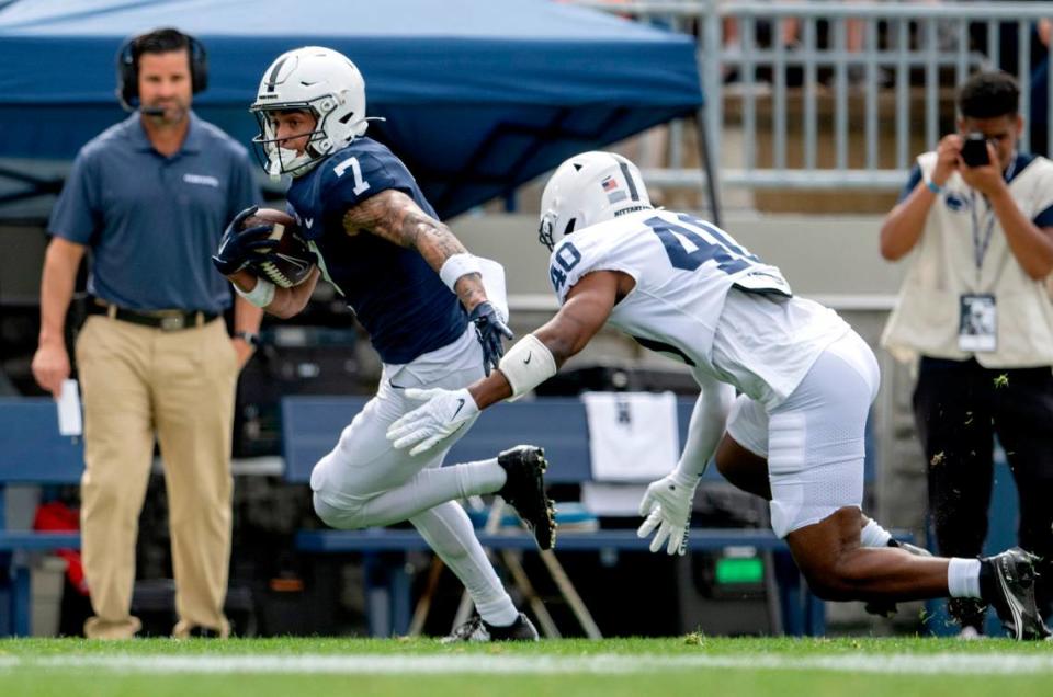 Wide receiver Kaden Saunders runs down the field with the ball from safety Patrick Williams during the Penn State Blue-White game on Saturday, April 15, 2023.