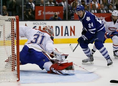 Oct 7, 2015; Toronto, Ontario, CAN; Toronto Maple Leafs forward Peter Holland (24) watches his shot on Montreal Canadiens goaltender Carey Price (31) just miss the net during the second period at the Air Canada Centre. John E. Sokolowski-USA TODAY Sports