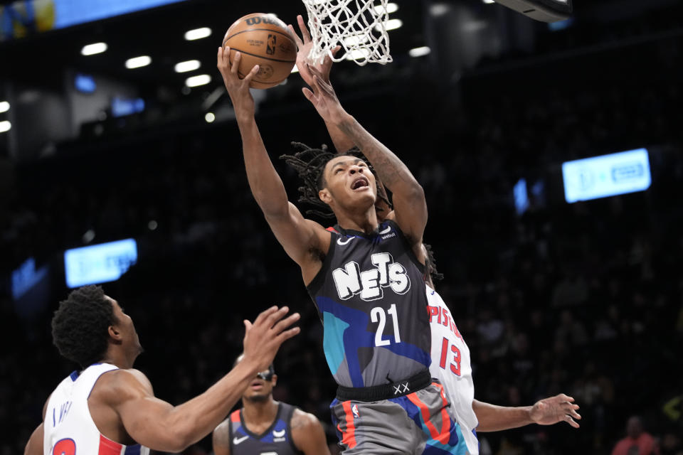 Brooklyn Nets forward Noah Clowney (21) goes to the basket against Detroit Pistons center James Wiseman (13) during the first half of an NBA basketball game, Saturday, April 6, 2024, in New York. (AP Photo/Mary Altaffer)