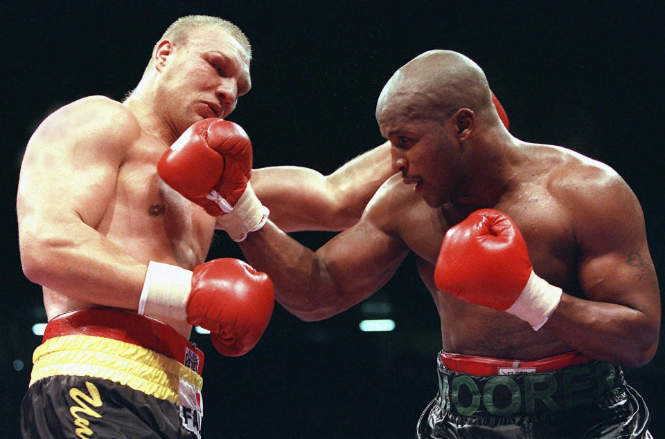 FILE - Germany's Axel Schulz, left, and Michael Moorer, right, fight in their IBF heavyweight world championship boxing match in Dortmund, Germany, June 22, 1996. Moorer was inducted Sunday, June 9, 2024, into the International Boxing Hall of Fame during a ceremony at the Turning Stone Resort Casino in Verona, N.Y. (AP Photo/Christof Stache, File)