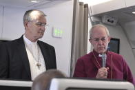 The Archbishop of Canterbury Justin Welby, right, and the Moderator of the General Assembly of the Church of Scotland Iain Greenshields meet the journalists during an airborne press conference aboard the airplane directed to Rome, at the end of his pastoral visit to Congo and South Sudan, Sunday, Feb. 5, 2023. (Tiziana Fabi/Pool Photo Via AP)