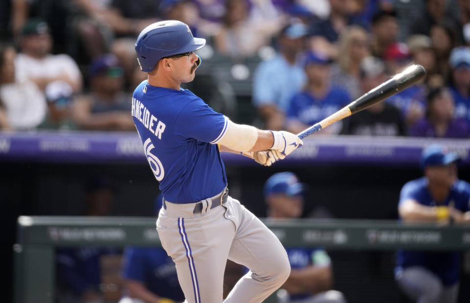 Toronto Blue Jays' Davis Schneider follows the flight of his RBI double off Colorado Rockies relief pitcher Tommy Doyle in the fifth inning of a baseball game Sunday, Sept. 3, 2023, in Denver. (AP Photo/David Zalubowski)