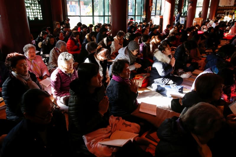 Parents pray for their children's success in the college entrance examinations at a Buddhist temple in Seoul