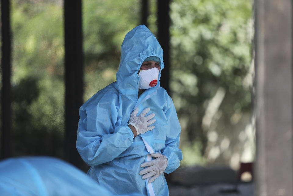 A relative of a person who died of COVID-19 reacts at a crematorium in Jammu, India, Sunday, April 25, 2021. India’s crematoriums and burial grounds are being overwhelmed by the devastating new surge of infections tearing through the populous country with terrifying speed, depleting the supply of life-saving oxygen to critical levels and leaving patients to die while waiting in line to see doctors. (AP Photo/Channi Anand)