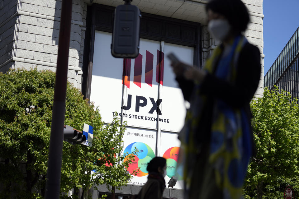 Person walk near Tokyo Stock Exchange building Thursday, April 27, 2023, in Tokyo. Asian stock markets were mixed Friday after Wall Street sank on worries about the health of U.S. banks that are under pressure from interest rate hikes. (AP Photo/Eugene Hoshiko)