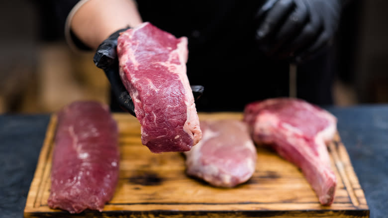 cutting cowboy ribeye steaks