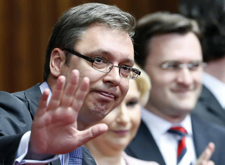 Serbian Prime Minister designate Aleksandar Vucic, left waves in the parliament, in Belgrade, Serbia, Sunday, April 27, 2014. Vucic announced that his government would be formed on Sunday. (AP Photo/Darko Vojinovic)