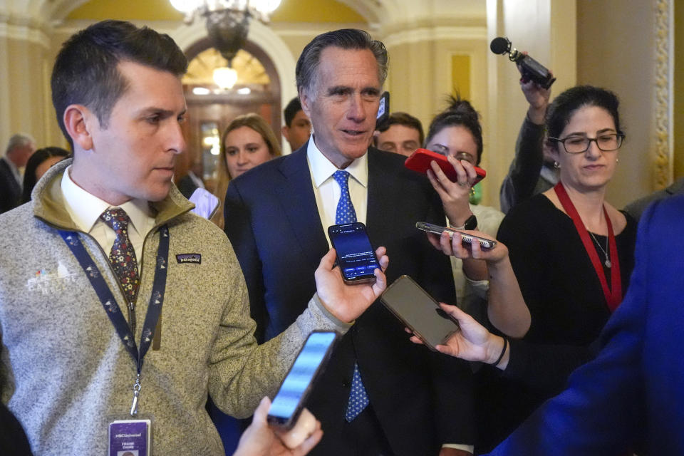 Sen. Mitt Romney, R-Utah, speaks with members of the media as he walks Wednesday, Feb. 28, 2024, at the Capitol in Washington. Earlier Sen. Mitch McConnell announced that he'll step down as Senate Republican leader in November. (AP Photo/Mark Schiefelbein)
