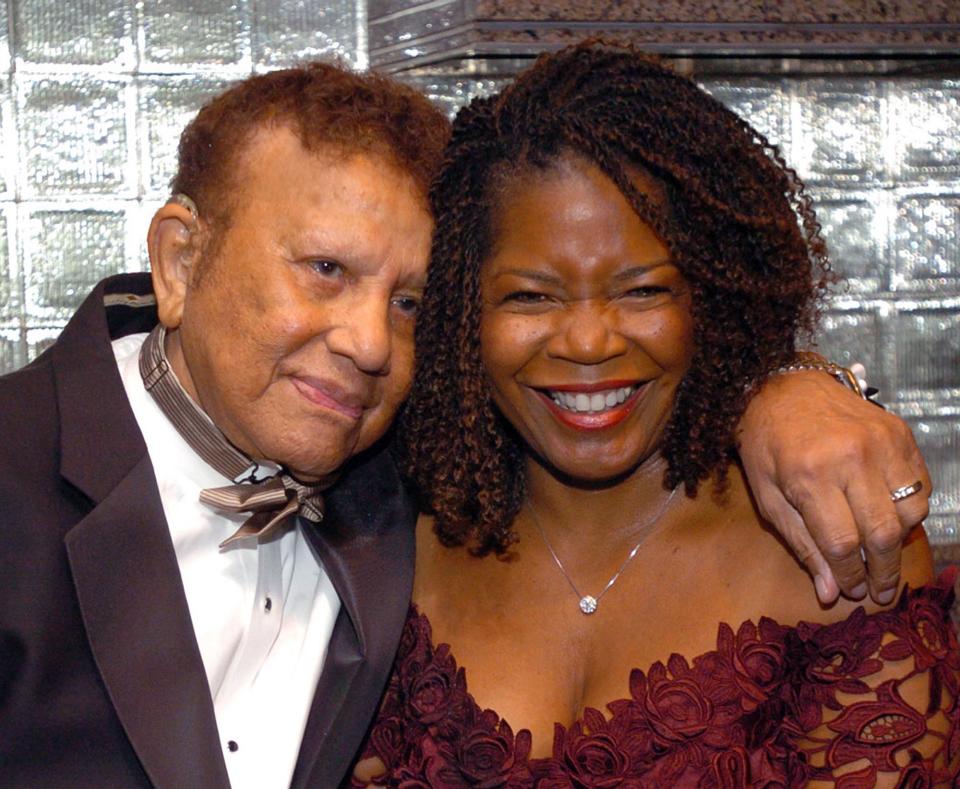 FILE- In this Nov. 3, 2004 file photo, Harold "Hal" Jackson and wife Debi share a moment before celebrating Jackson's 65 years of broadcasting at a benefit for the Youth Development Foundation, at the Rainbow Room in New York. Jackson, who was the first African-American voice on network radio, died Wednesday, May 23, 2012. He was in his late 90s. (AP Photo/Gina Gayle, File)