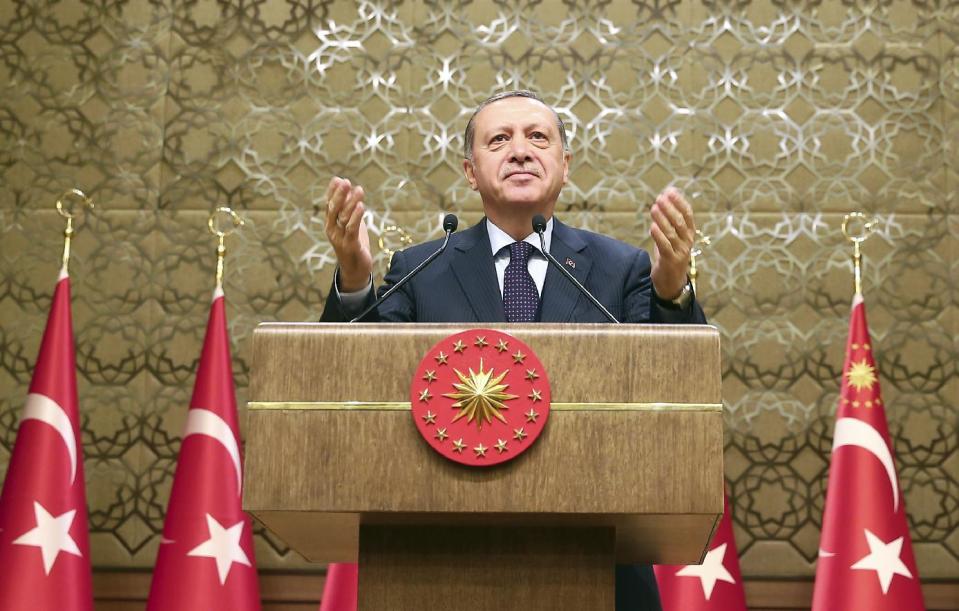 Turkey's President Recep Tayyip Erdogan gestures, during a meeting with local media representatives, in Ankara, Turkey, Wednesday, March 22, 2017. Tensions between Turkey and Europe have boiled in recent weeks, but acrimony over Turkey's belief that some European countries are harboring suspected terrorists has festered for years. Erdogan criticized Germany Wednesday for allowing a weekend rally of Kurds, some of whom expressed support for a jailed rebel leader in Turkey.(Kayhan Ozer/Presidential Press Service, Pool Photo via AP)