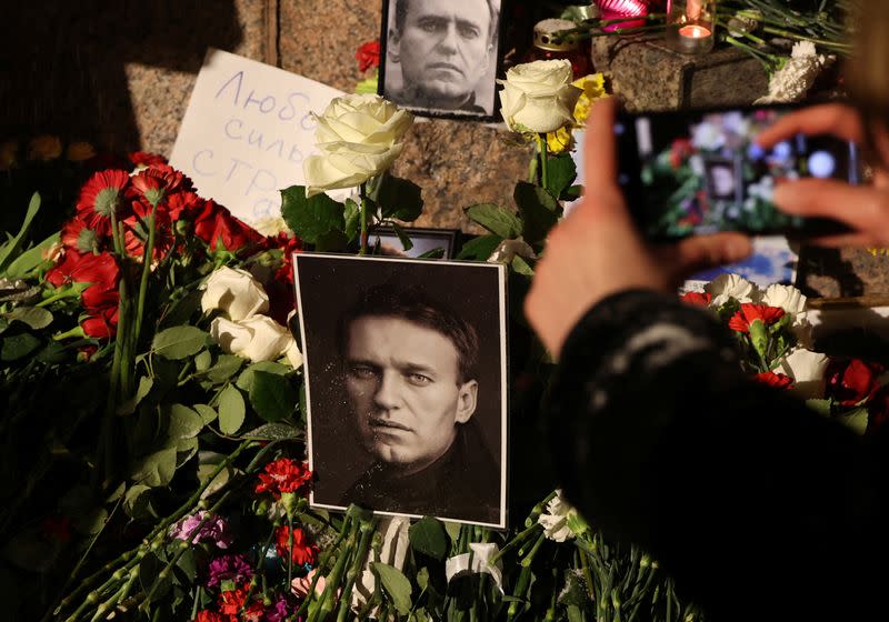 People gather at the monument to the victims of political repressions following the death of Alexei Navalny in Saint Petersburg