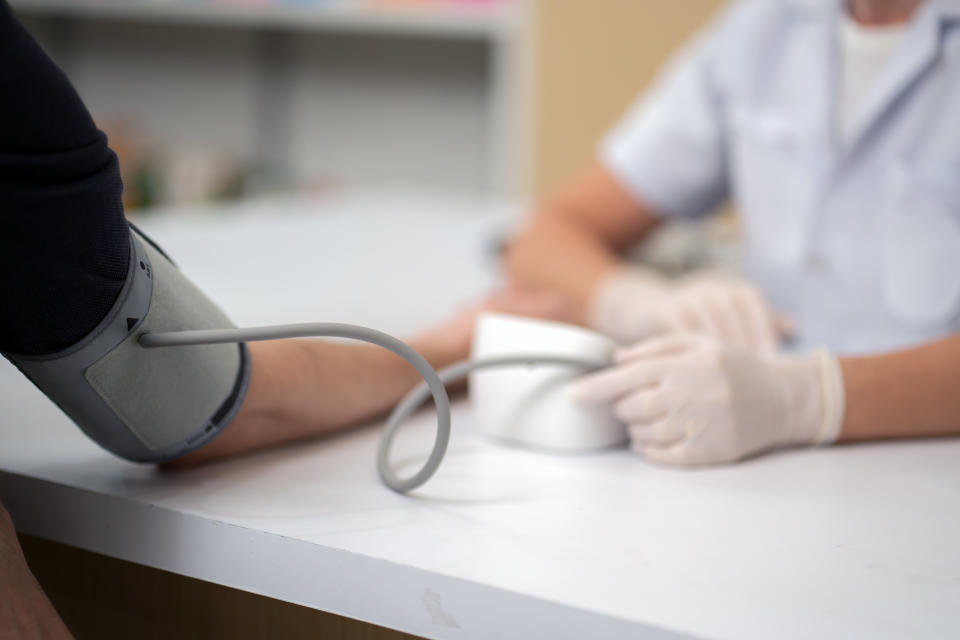 Senior female doctor is checking the blood pressure of the patient. blood pressure checks and monitoring .