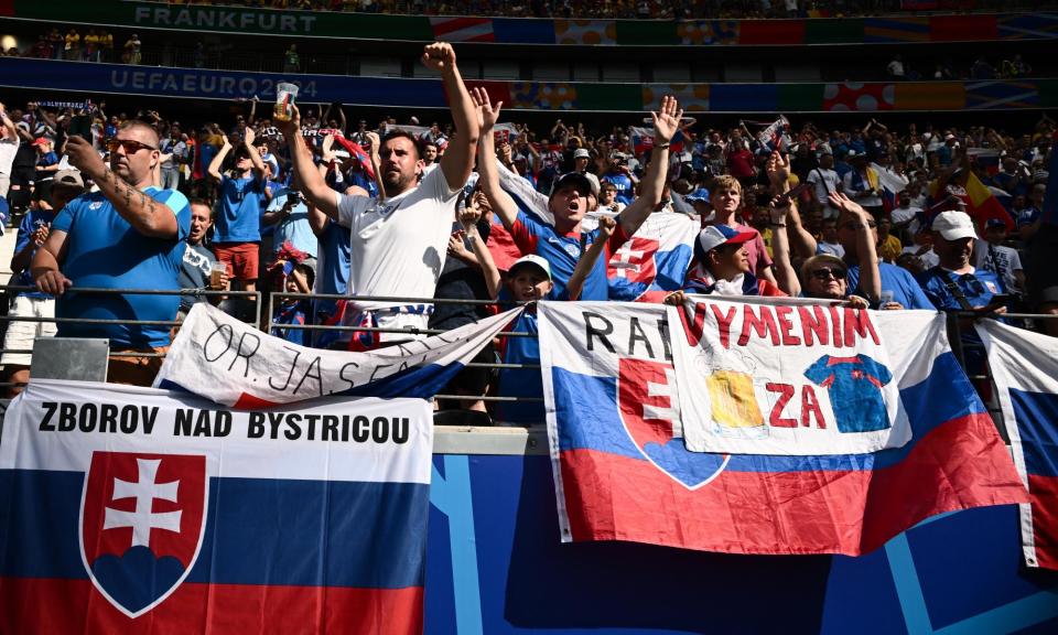<span>Slovakia fans cheer on the team during the final group game against Romania.</span><span>Photograph: Angelos Tzortzinis/AFP/Getty Images</span>