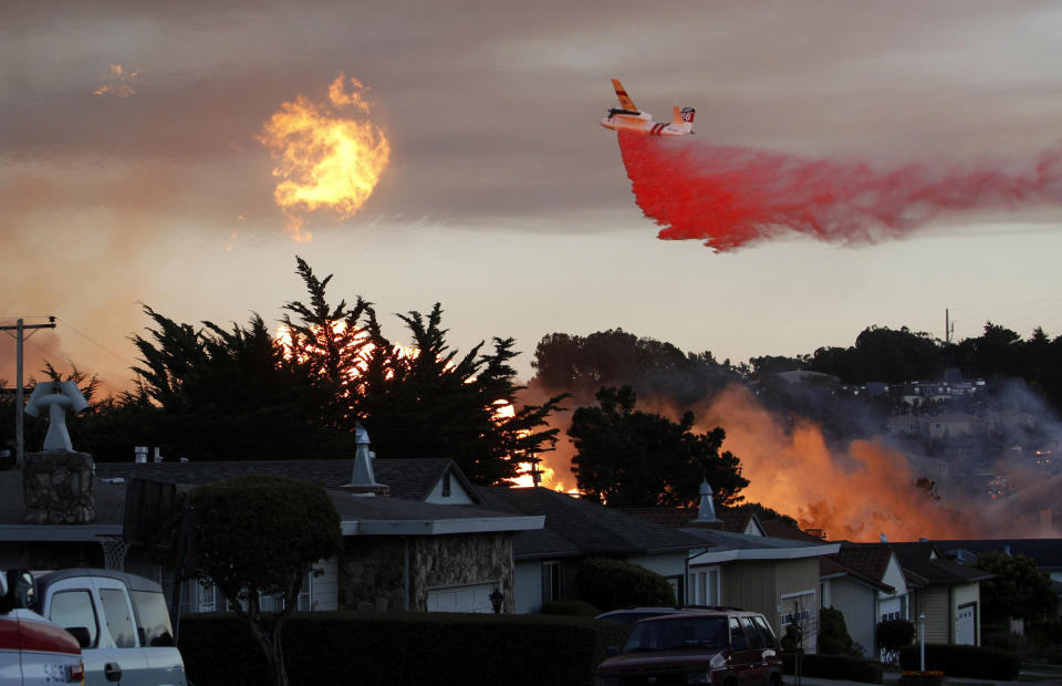 FILE - In this Sept. 9, 2010, file photo, a massive fire following a pipeline explosion roars through a mostly residential neighborhood in San Bruno, Calif. A federal judge repeatedly ripped into Pacific Gas & Electric, saying its executives have put greed before safety. U.S. District Judge William Alsup told the utility at a hearing Wednesday, Feb. 19, 2020, that it should plan to have at least 1,100 more tree trimmers to reduce the chances that it will cause even more devastation. The harsh rebuke came in a hearing as part of PG&E's criminal probation imposed after its natural gas lines blew up a San Bruno, California, neighborhood and killed eight people. Since its probation, poorly maintained power lines have been blamed for igniting wildfires that killed nearly 130 people and destroyed thousands of homes. (AP Photo/Jeff Chiu, File)