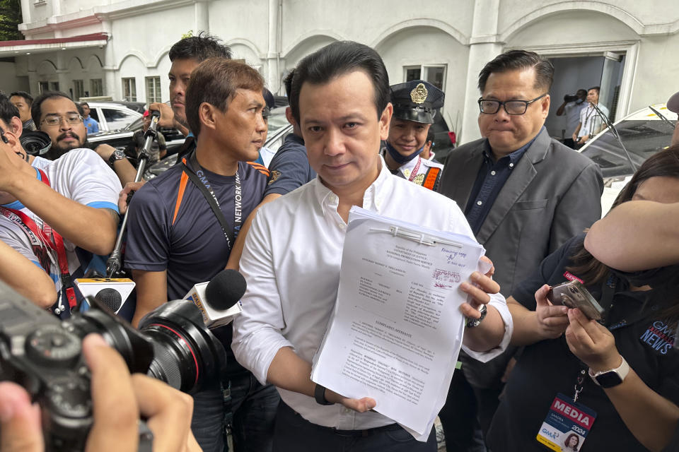 Former Sen. Antonio Trillanes holds documents to reporters after filing at the Department of Justice in Manila, Philippines on Friday July 5, 2024. Trillanes filed criminal complaints of economic plunder against ex-President Rodrigo Duterte Friday over alleged anomalies in the awarding of large numbers of government infrastructure projects worth billions of pesos (millions of dollars) to two companies when he was a southern city mayor and later as president. (AP Photo/Joeal Calupitan)