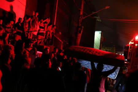 Residents are seen during a fire at Educando neighbourhood, a branch of the Rio Negro, a tributary to the Amazon river, in the city of Manaus, Brazil December 17, 2018. REUTERS/Bruno Kelly