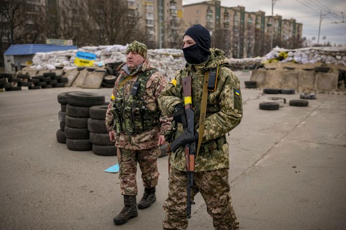 A Ukrainian serviceman has &quot;Mommy&quot; written on his weapon strap as he stands guard at a checkpoint on a main road in Kyiv, Ukraine.