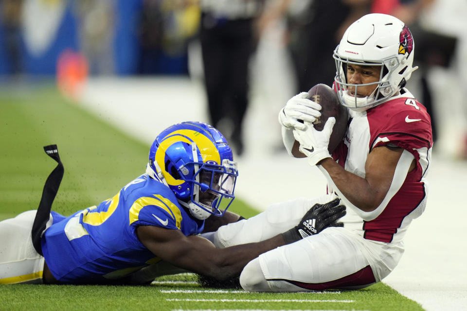 Arizona Cardinals wide receiver Rondale Moore (4) falls in-bound after making a catch in front of Los Angeles Rams cornerback David Long Jr. during the second half of an NFL football game Sunday, Nov. 13, 2022, in Inglewood, Calif. (AP Photo/Jae C. Hong)