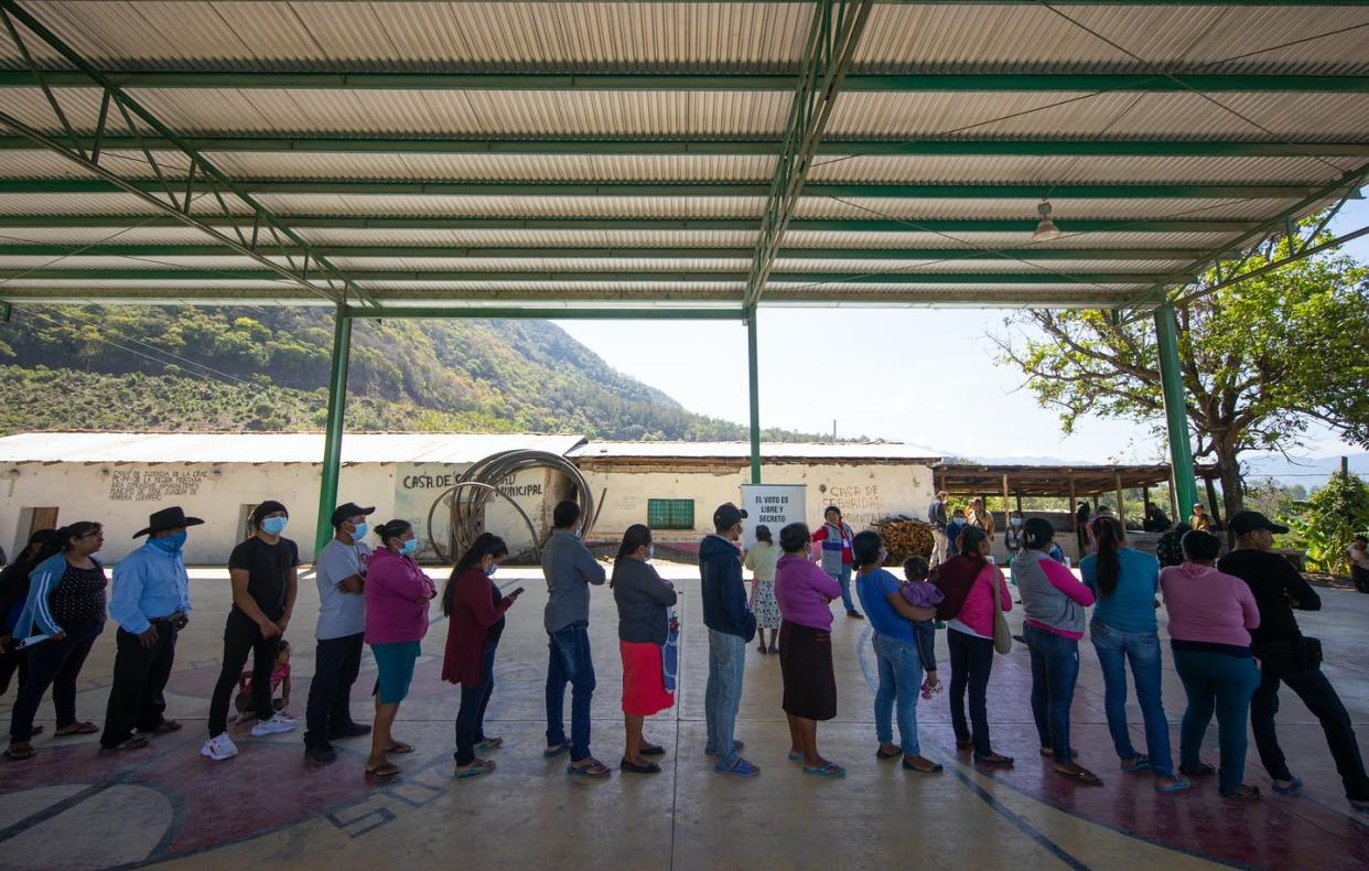 <span class="caption">Voters line up to cast their ballots at a polling station in Ayahualtempa, Mexico, on June 6, 2021. </span> <span class="attribution"><a class="link " href="https://www.gettyimages.com/detail/news-photo/voters-line-up-for-their-turn-to-cast-their-ballots-at-a-news-photo/1322185648?adppopup=true" rel="nofollow noopener" target="_blank" data-ylk="slk:Hector Vivas/Getty Images;elm:context_link;itc:0;sec:content-canvas">Hector Vivas/Getty Images</a></span>