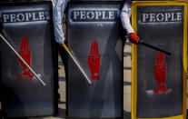 Anti-coup protesters hold makeshift shields during a demonstration in Yangon, Myanmar Tuesday, March 9, 2021. Demonstrators in Myanmar's biggest city came out Monday night for their first mass protests in defiance of an 8 p.m. curfew, seeking to show support for an estimated 200 students trapped by security forces in a small area of one neighborhood. (AP Photo)