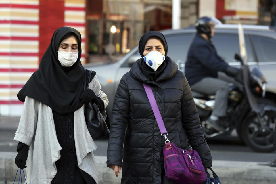 People wear masks to help guard against dangerous levels of air pollution in Tehran, Iran, Monday, Dec. 23, 2019. Poor air quality forced Iran’s government on Monday to keep all schools closed in the capital, Tehran, and other cities. Schools were closed since Saturday, and will remain closed until Wednesday, the end of the week in Iran, according to the official IRNA news agency. Tehran’s air is among the most polluted in the world. (AP Photo/Ebrahim Noroozi)